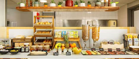 A breakfast buffet with various food items, including fruits, cereals, and dairy products.