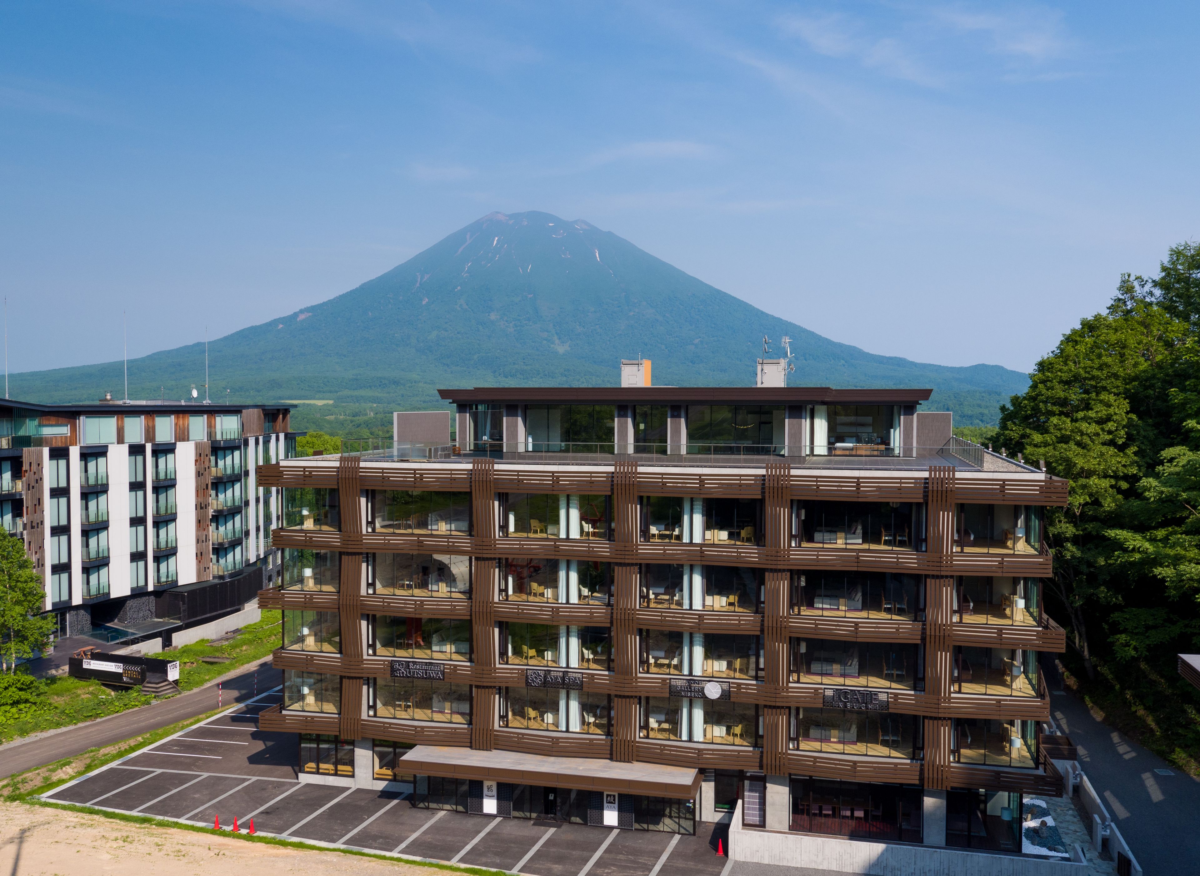 A multi-story hotel with a modern design, featuring balconies and large windows.