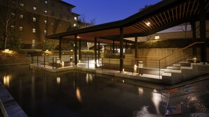 A modern building with a covered outdoor area, a pool, and a staircase leading to an upper level. - Saiounomiya (Ise)