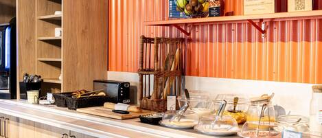 A breakfast bar with a toaster, bread, and a wicker basket.