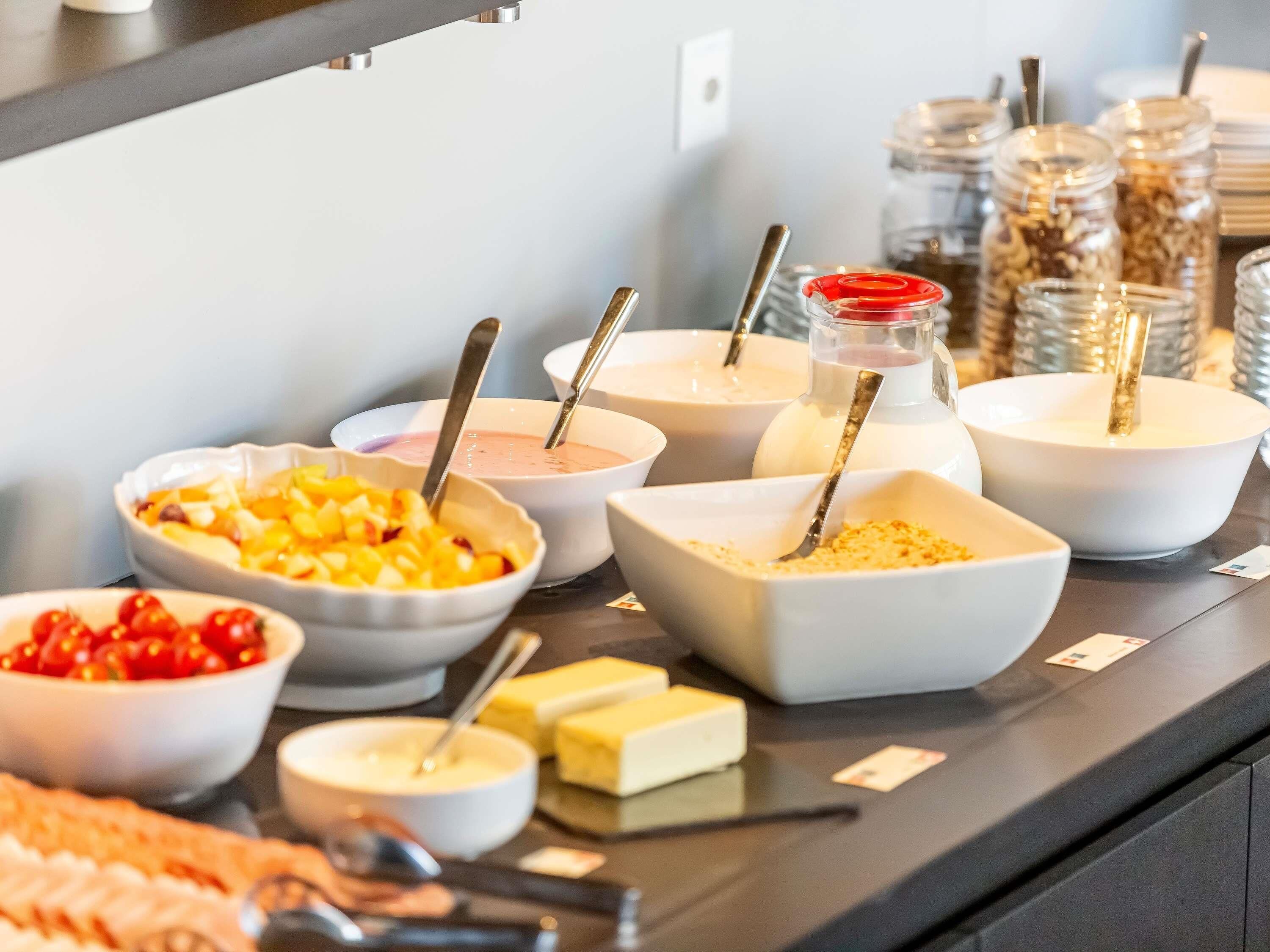 A buffet with various food items and utensils.