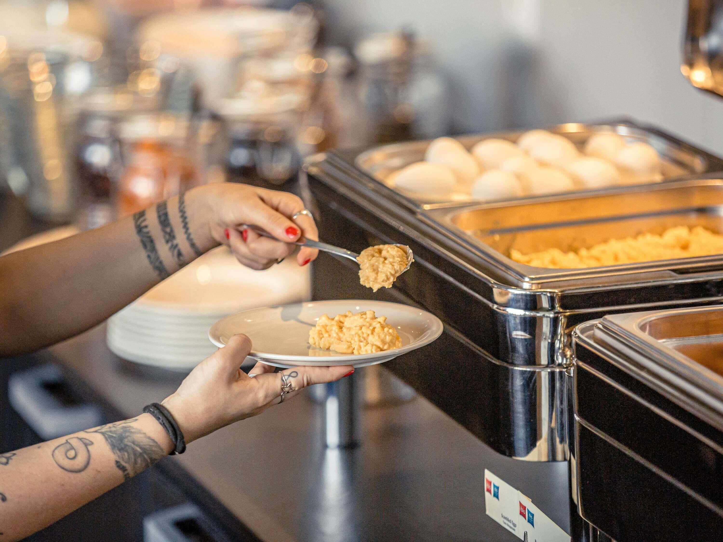 A buffet setup with various food items in containers.
