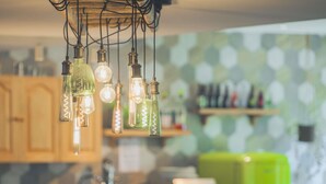A kitchen with hanging light fixtures, a green refrigerator, and a patterned backsplash. - greet hotel Annecy Cran Gevrier (Annecy)