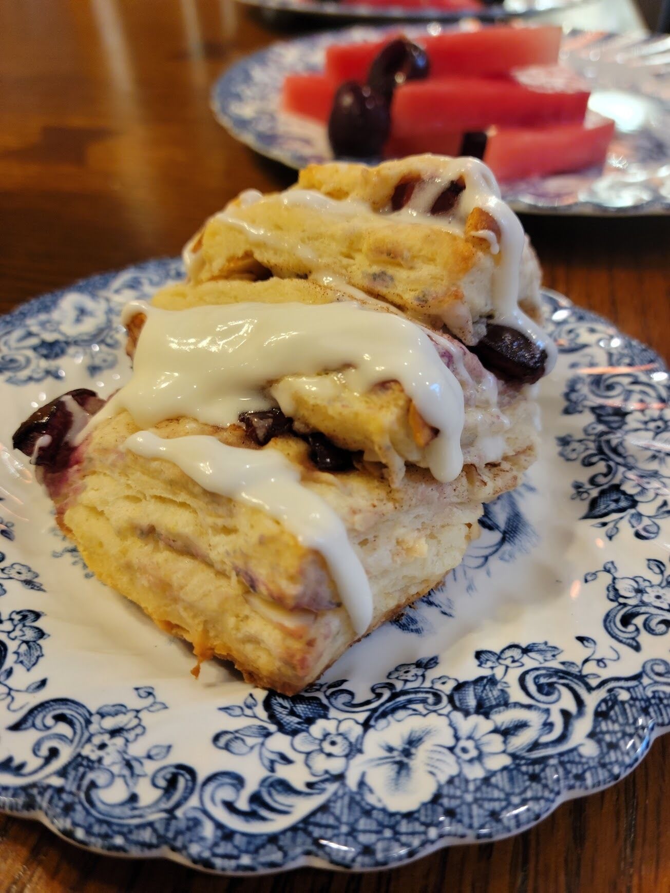 A plate of scones with clotted cream and jam.