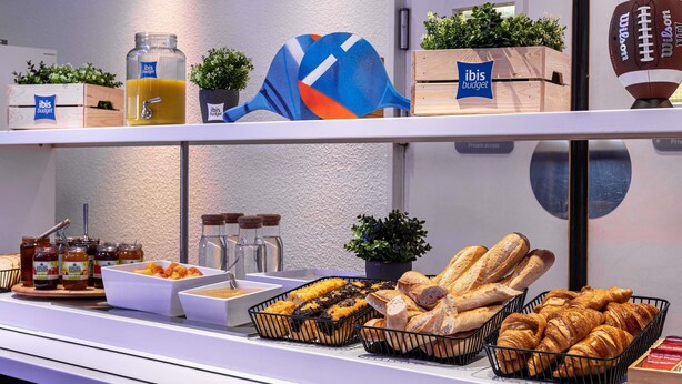 A breakfast buffet with various food items and a football decoration. - ibis budget Wien Messe (Vienna)