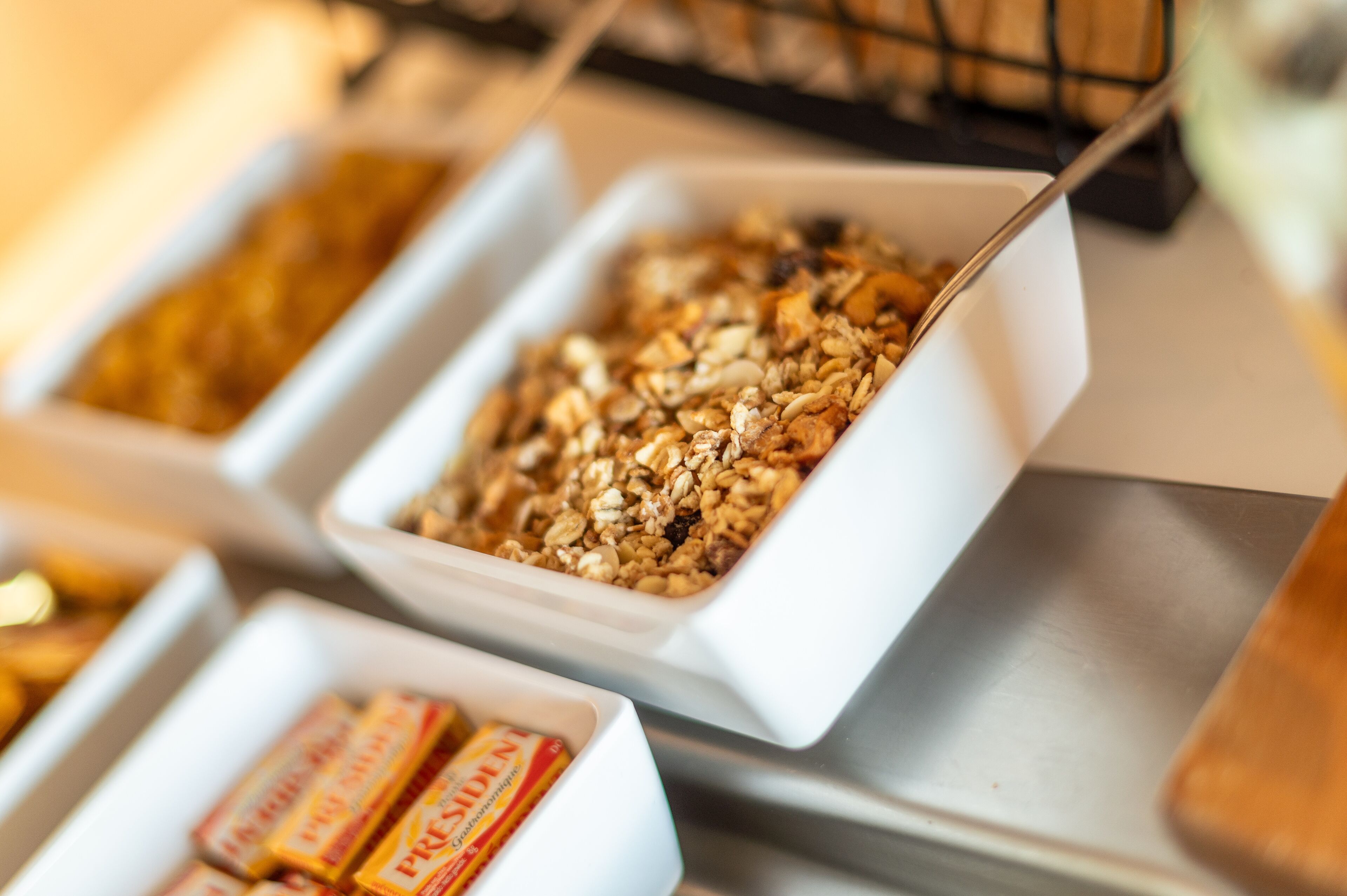 Ein Buffet mit verschiedenen Speisen, darunter Granola und Müsliriegel.
