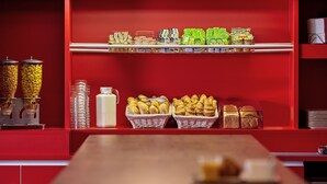 A breakfast buffet with various food items and beverages.