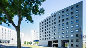 A modern building with a flat facade and multiple windows. - ibis budget Basel City (Basel)