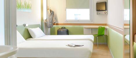 A hotel room with two beds, a desk, a chair, a suitcase, and a TV.