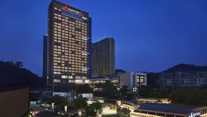 A Marriott hotel with multiple floors, a modern design, and a well-lit facade.