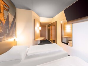 A hotel room with two beds, a hallway, and a bathroom. -  B&B HOTEL Essen-Nord (Essen)