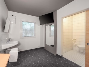 A modern bathroom with a sink, mirror, and window. - B&B HOTEL Berlin Genshagen-Nord (Ludwigsfelde)