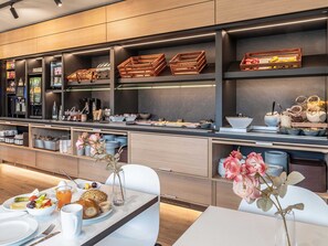 A modern breakfast buffet with various food items and beverages, wooden crates, and a clean, minimalist design. - B&B HOTEL Mainz-Süd (Mainz)