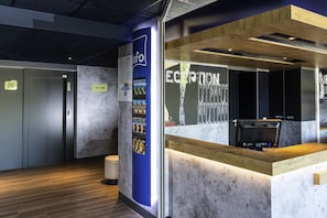 Welcome to our reception area, featuring a computer station and information stand with brochures and a phone number.