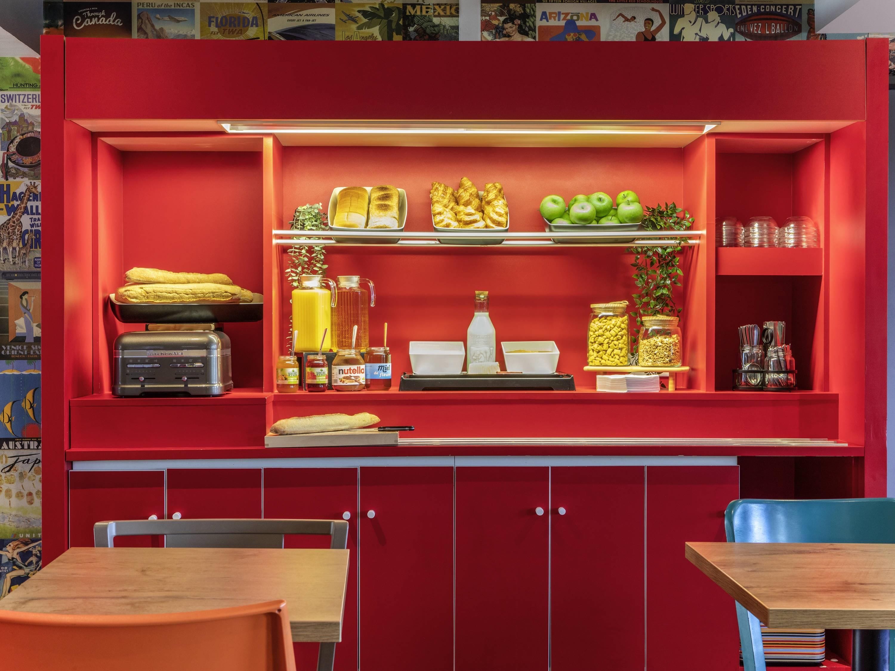 A red-framed display case with food items, a scale, and a vintage radio.