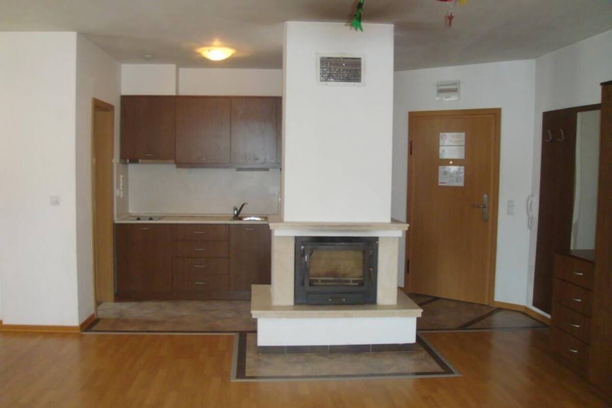 A compact kitchen with wooden cabinets, a built-in oven, and a small countertop.