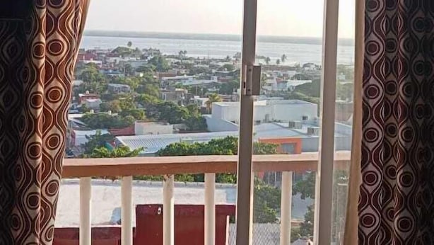 A room with a large window overlooking a cityscape.