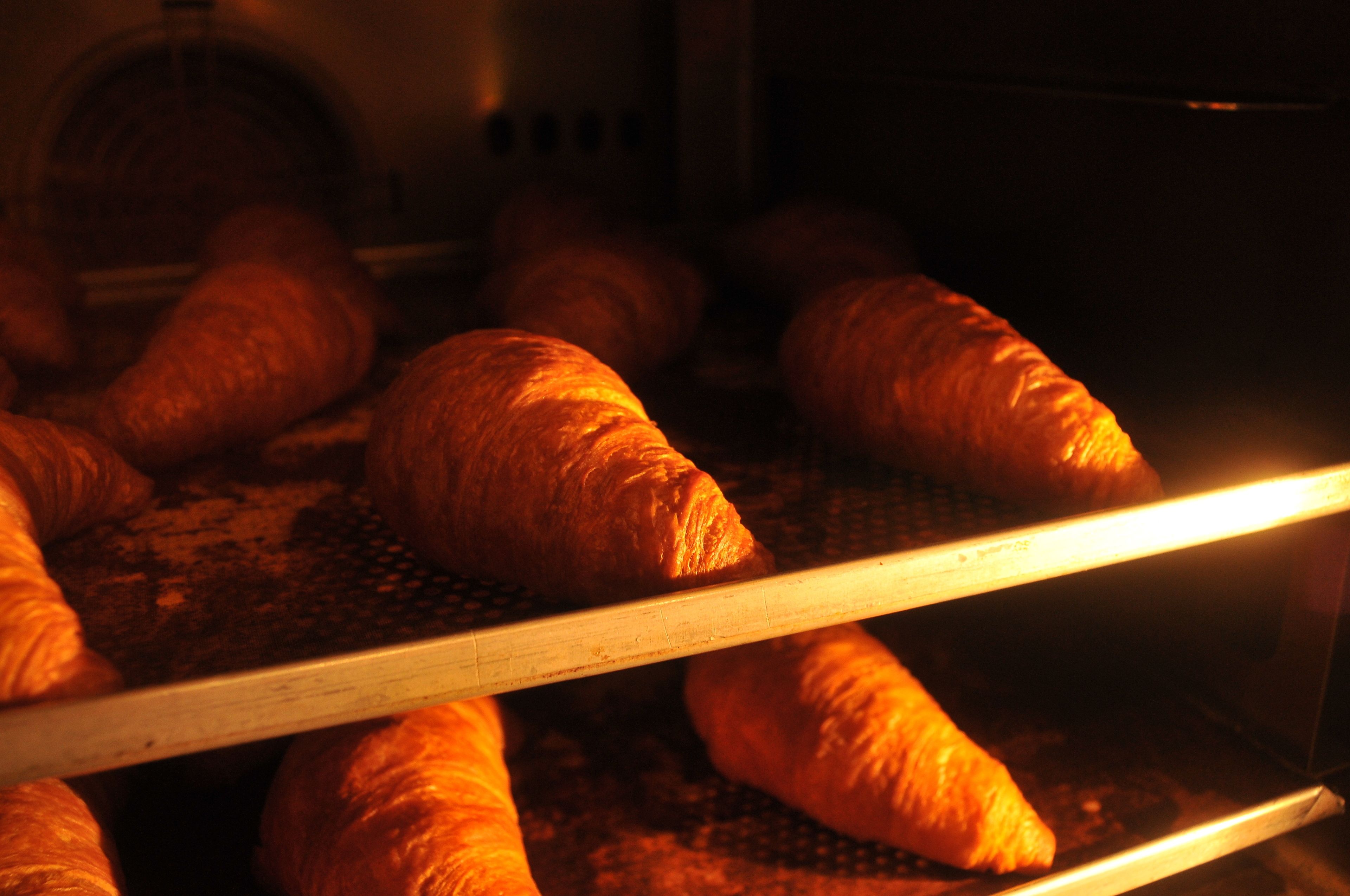 A bakery with multiple croissants on display.