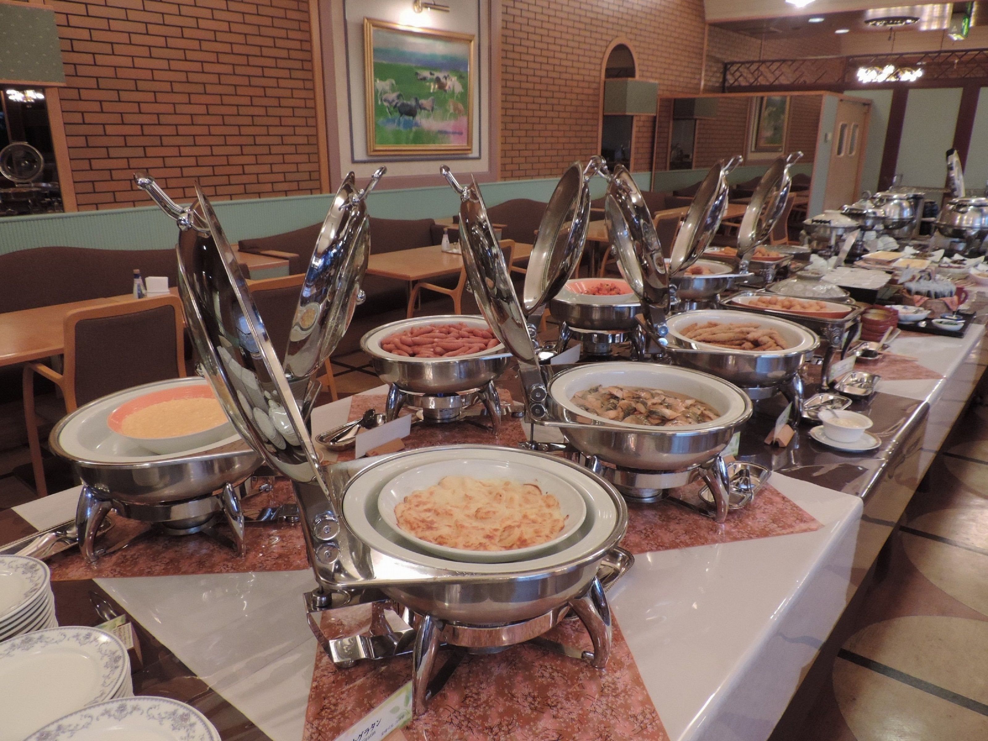 A buffet setup with multiple self-service stations, each with a variety of dishes.