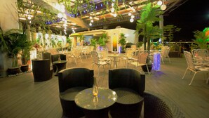 An indoor dining area with wicker furniture, hanging plants, and ambient lighting. - Lace Boutique Hotel (Johor Bahru)