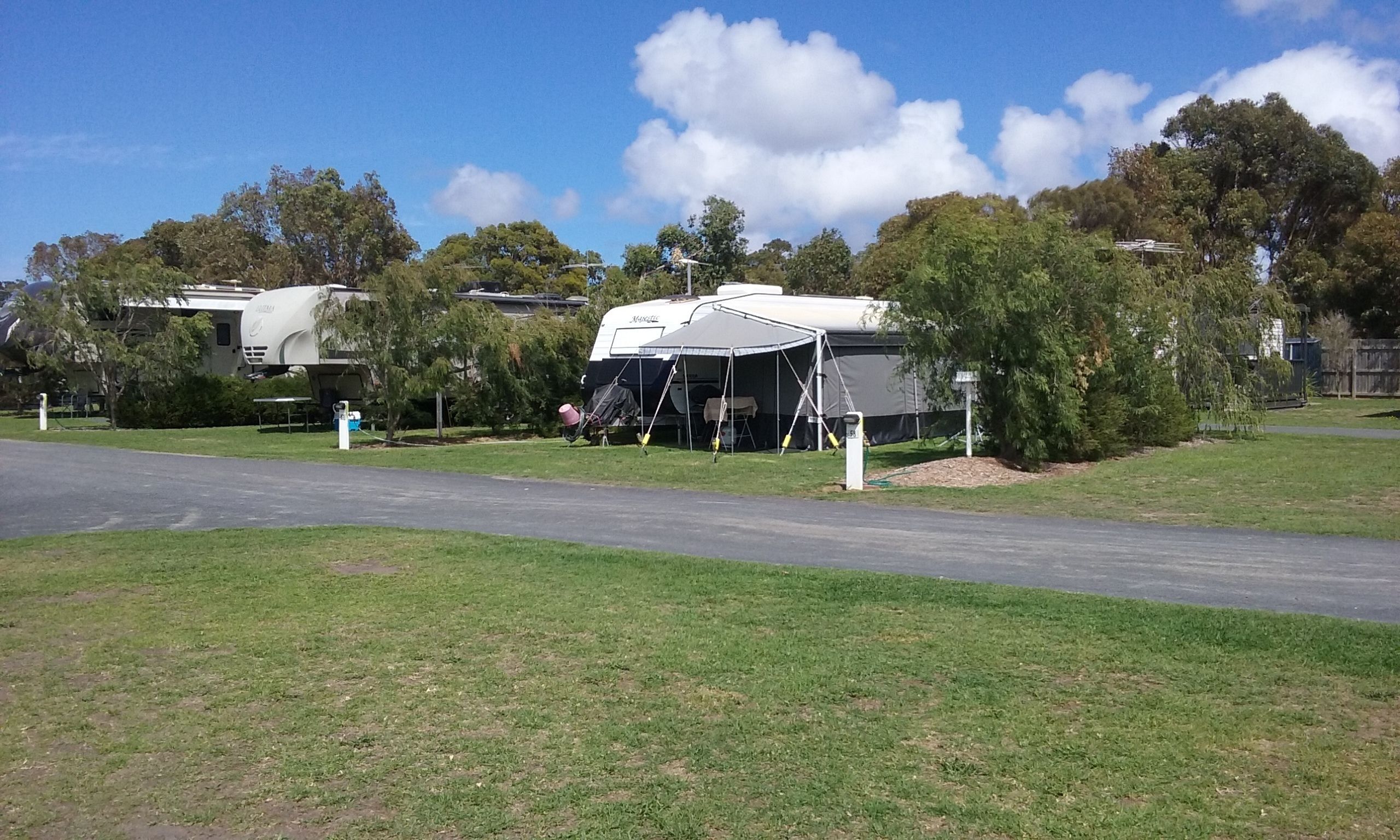 A campsite with RVs and a tent.