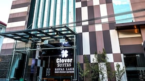 A hotel with a modern design, featuring a checkered facade and large windows. - Clover Suites Royal Lake Yangon (Yangon)