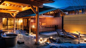 A spa area with a hot tub, seating, and a wooden deck. - Sennomori (Ise)