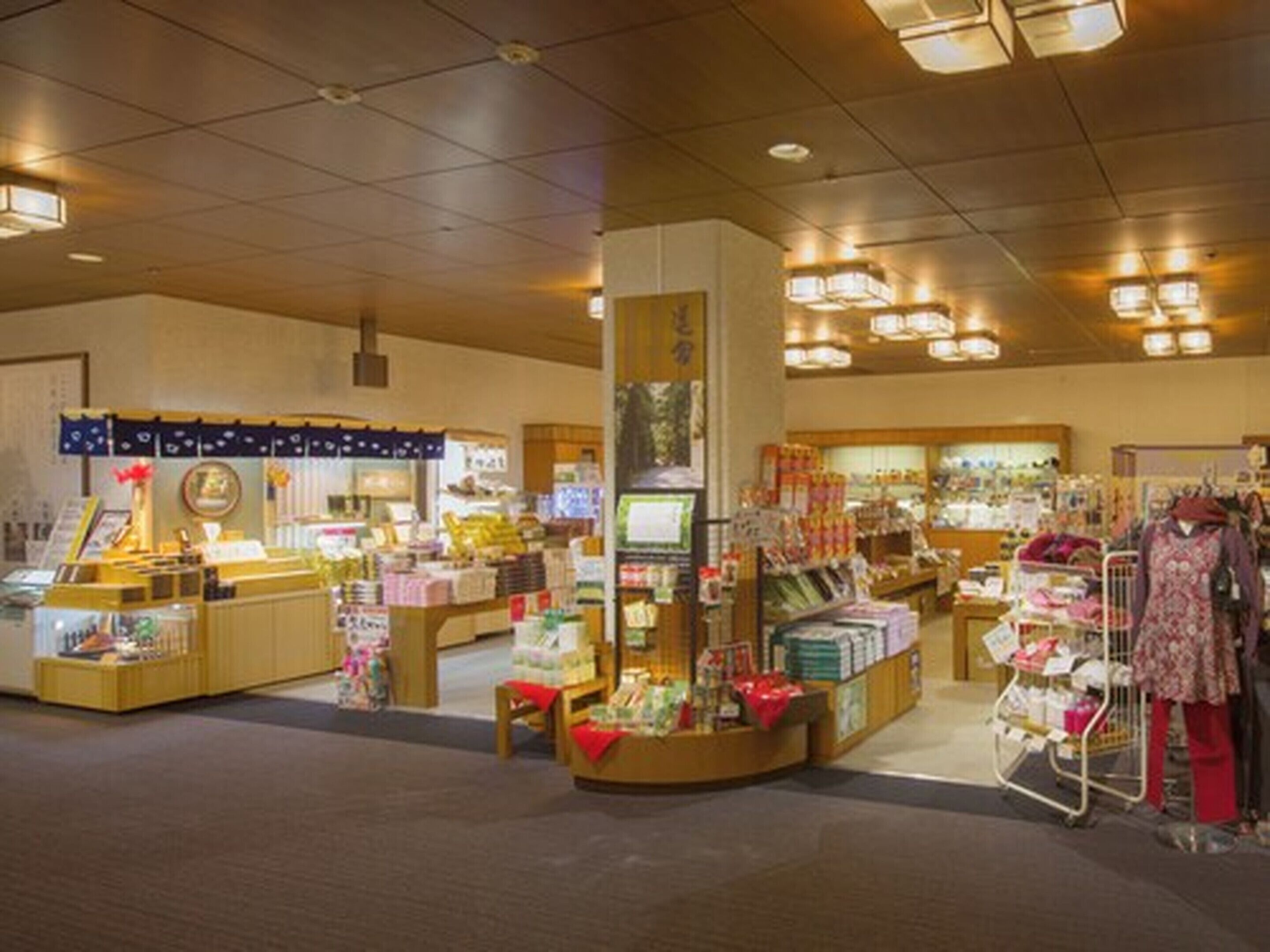 A retail store with various products on shelves and counters, including clothing and household items.