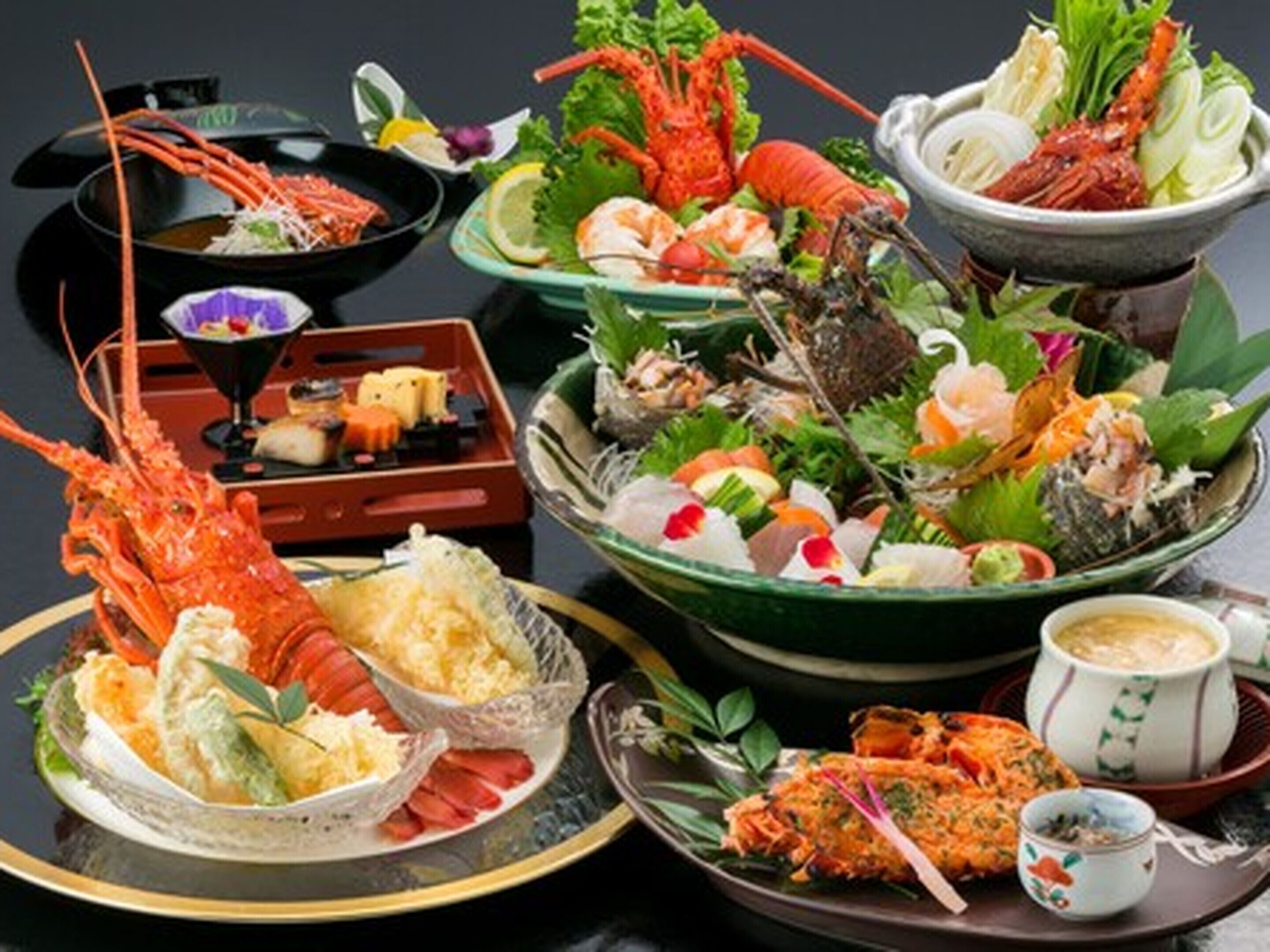 A variety of seafood dishes, including lobster, shrimp, and sashimi, arranged on plates and bowls.