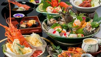 A variety of seafood dishes, including lobster, shrimp, and sashimi, arranged on plates and bowls.