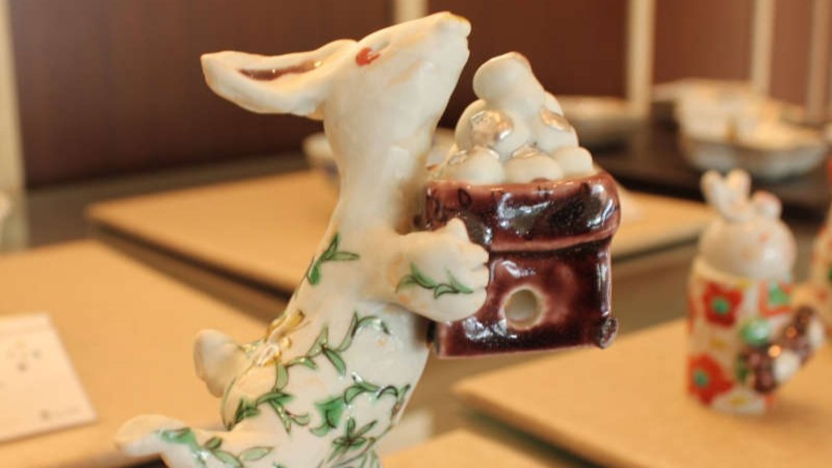 A ceramic dog figurine holding a bowl of food.