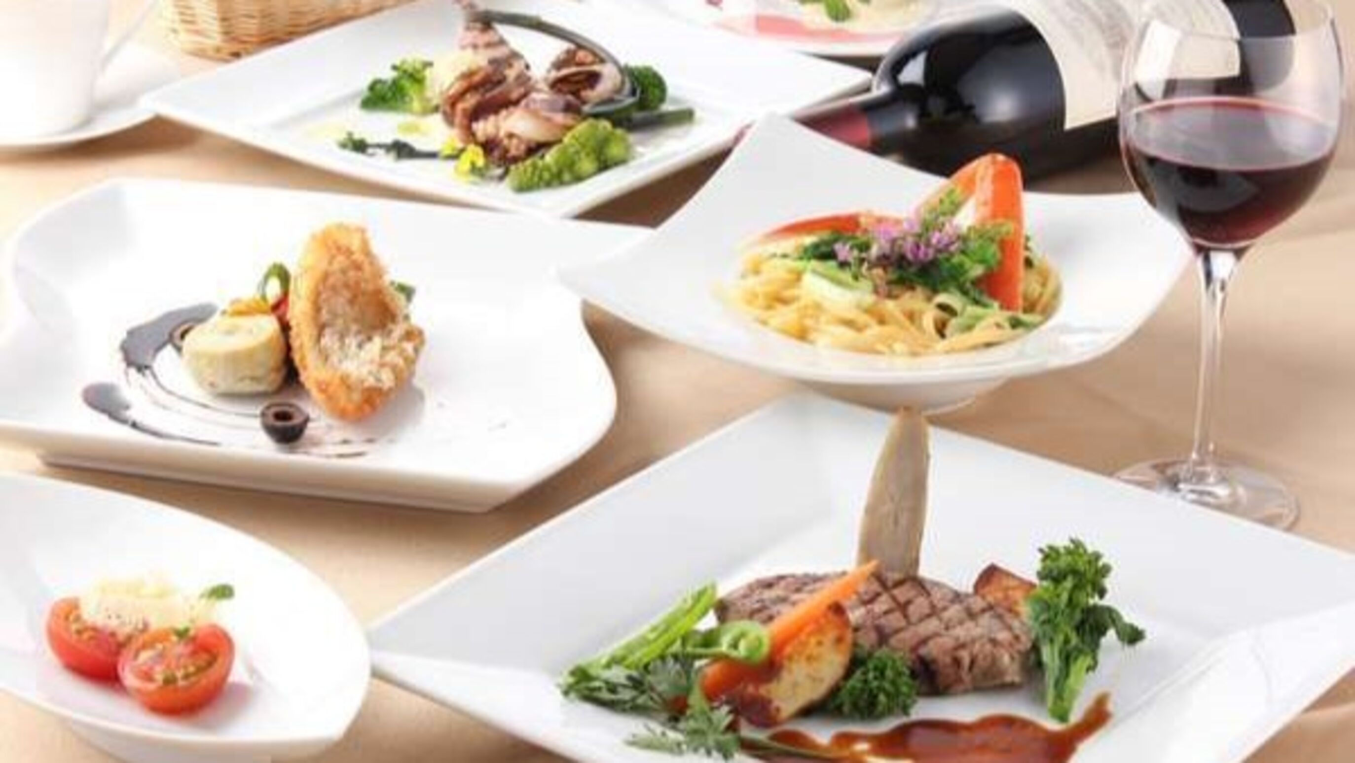 A variety of plated dishes, including pasta, steak, and seafood, suggesting a fine dining restaurant setting.