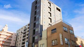 A multi-story hotel building with balconies and signage indicating it is a hotel.