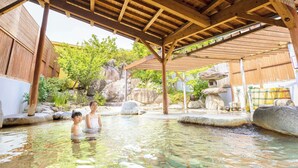 A traditional Japanese onsen with wooden beams and stone structures.
