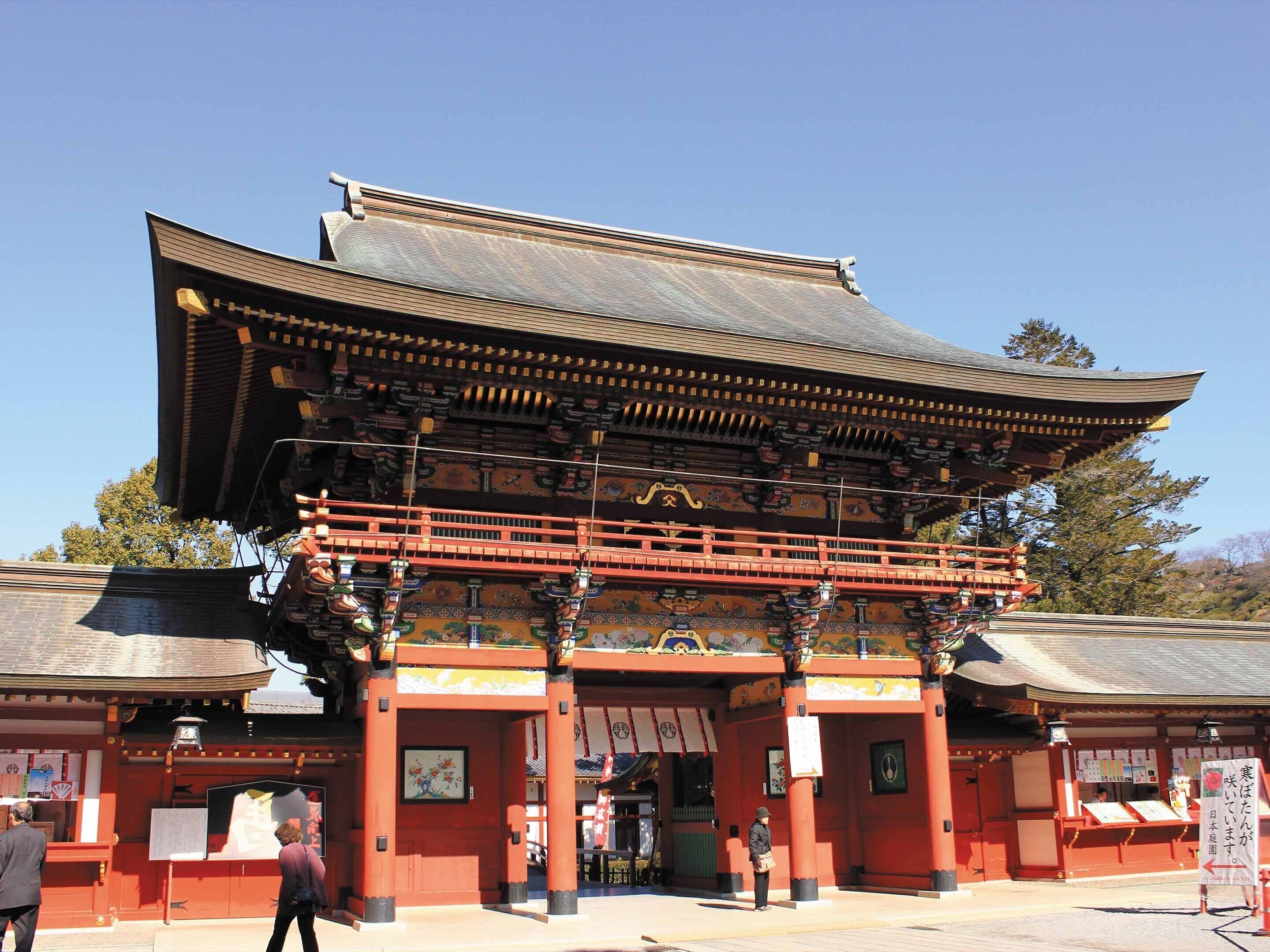Un bâtiment traditionnel japonais, doté d’un toit incurvé et de piliers rouges.