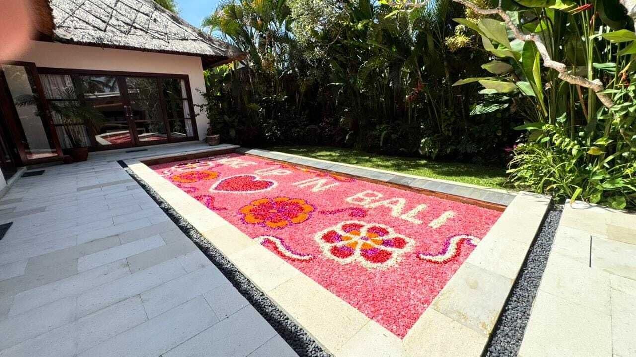 A courtyard with a tiled floor and a decorative flower pattern.