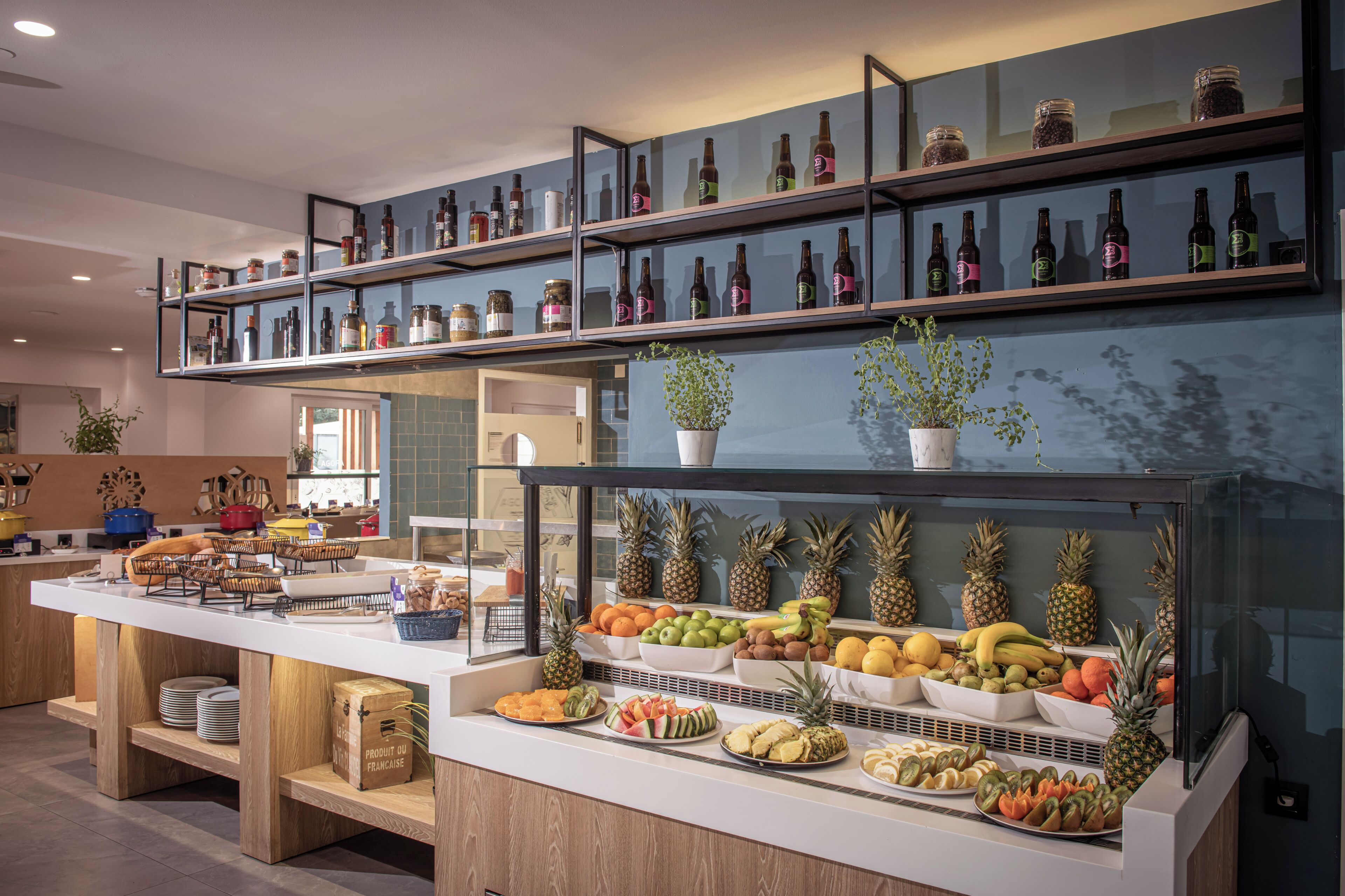 A buffet with various fruits and beverages on display.