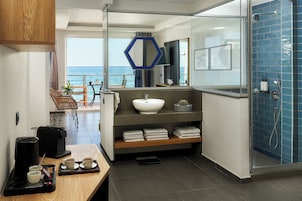 Junior Suite Sea Front | Bathroom | Shower, rainfall showerhead, eco-friendly toiletries, hair dryer