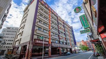 A multi-story hotel with a prominent entrance and signage indicating it is a hotel.