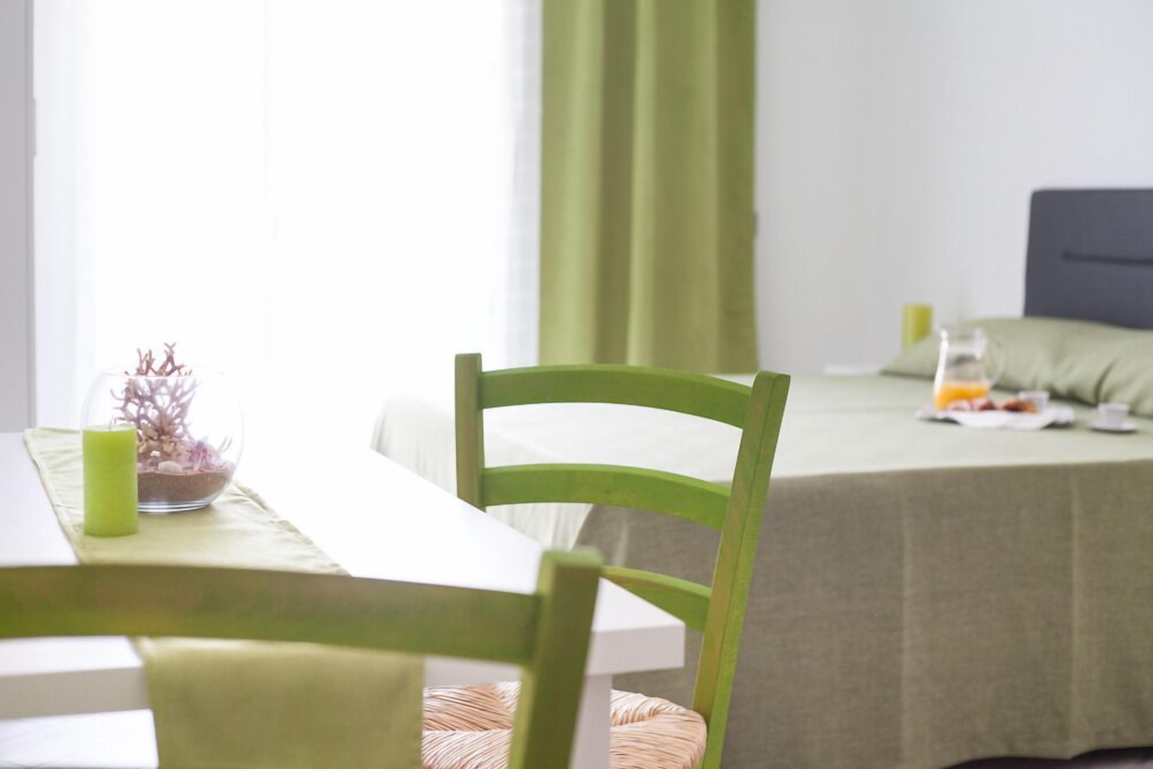 A room with a dining table and a bed.