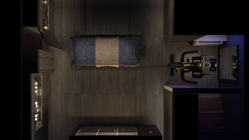 Une chambre compacte et moderne, dotée d’une lucarne, d’un lit, d’un bureau et d’une petite kitchenette.