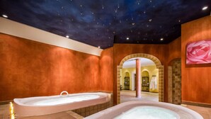 A spa area with two hot tubs, a starry ceiling, and a large pink rose painting on the wall. - Hotel und Landgasthof Altwirt (Holzkirchen)