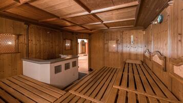 A wooden interior with benches and a small counter.