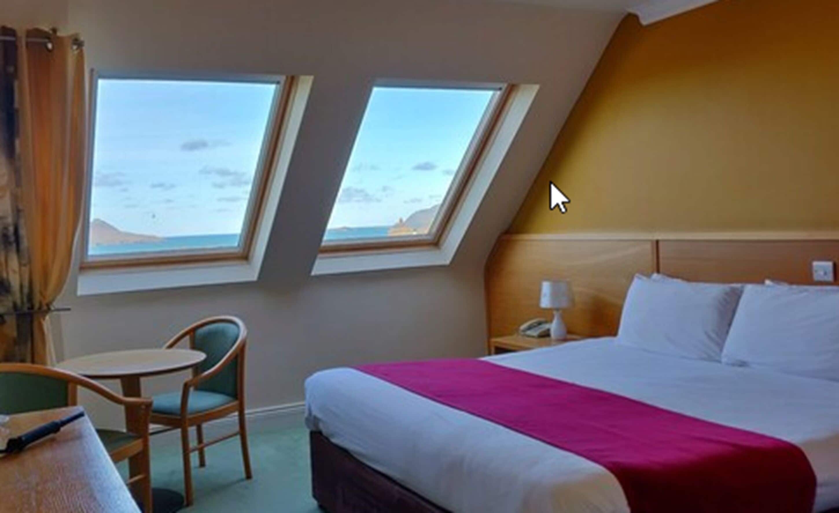 deluxe double room, ocean view | in-room safe, desk, laptop workspace, blackout curtains