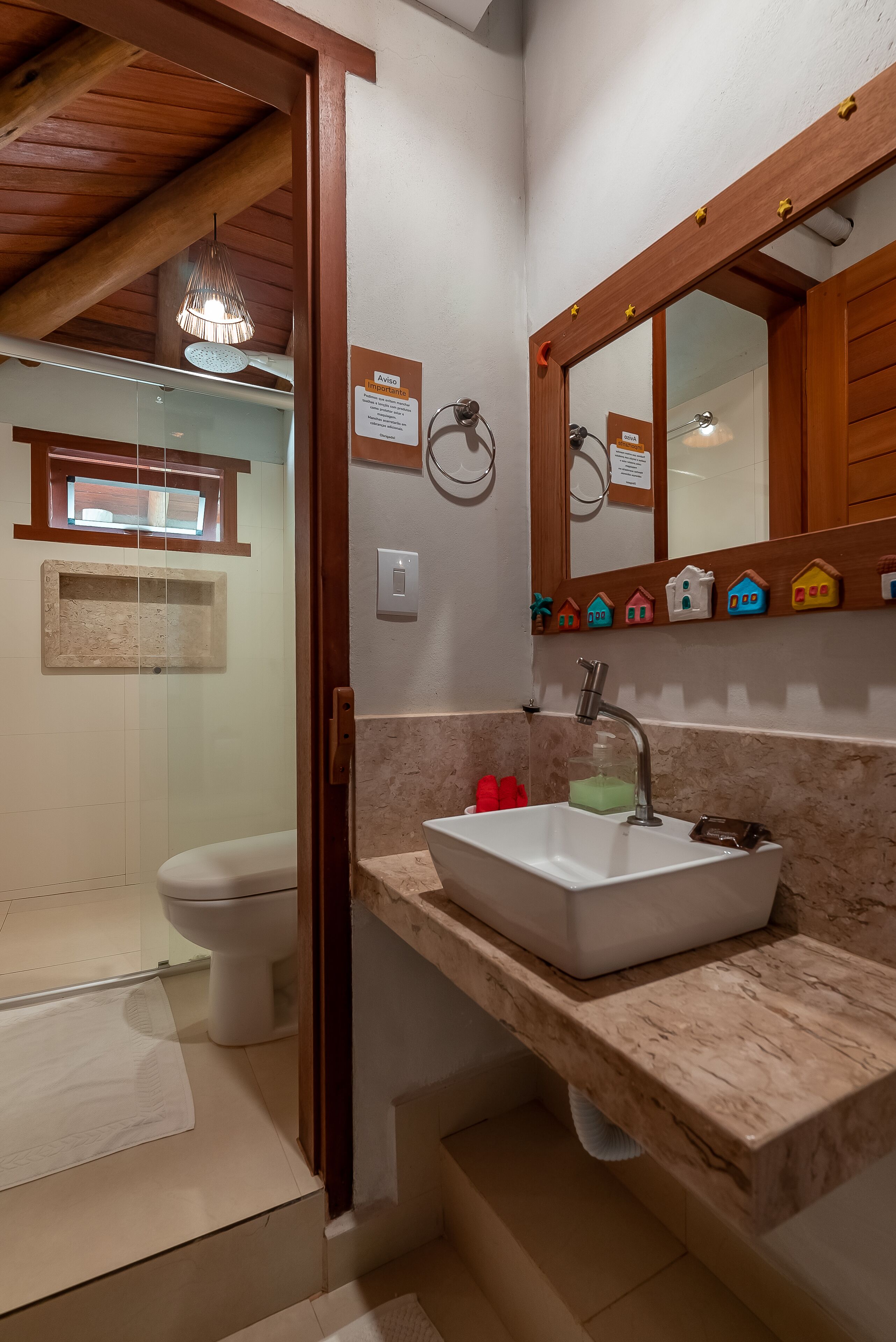 A bathroom with a shower, toilet, and sink.