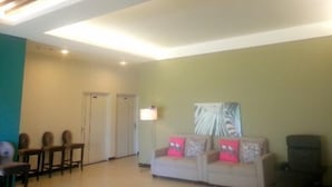 A living room with a sofa, chairs, a table, and a ceiling with recessed lighting. - Sunrise Villa (Beinan)