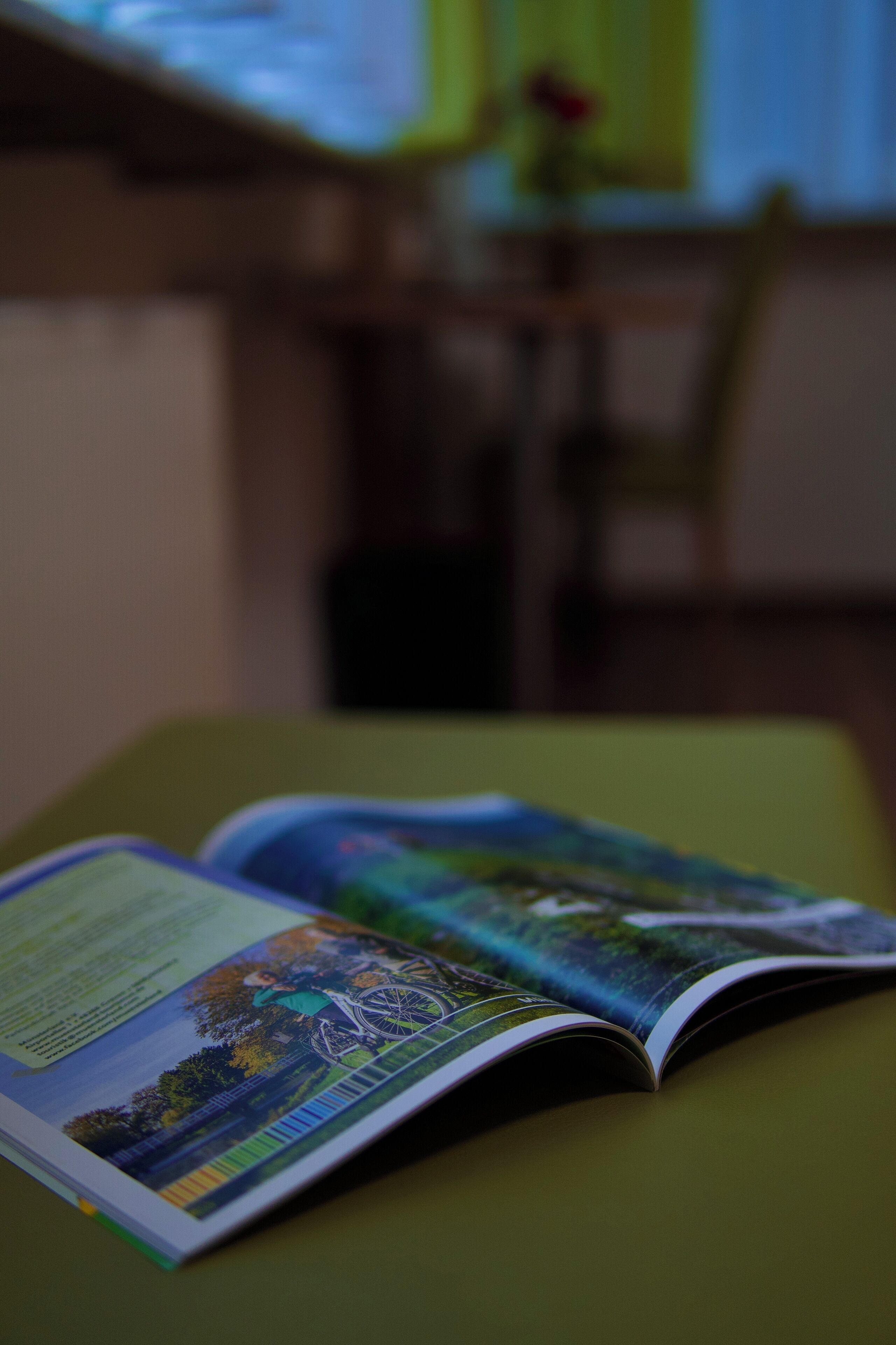 An open magazine on a green surface.