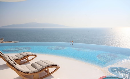 Seasonal outdoor pool, open 9:00 AM to 7:00 PM, pool umbrellas