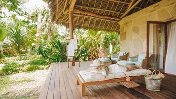 Relax in a serene outdoor lounge with comfortable seating and a casual dining area.
