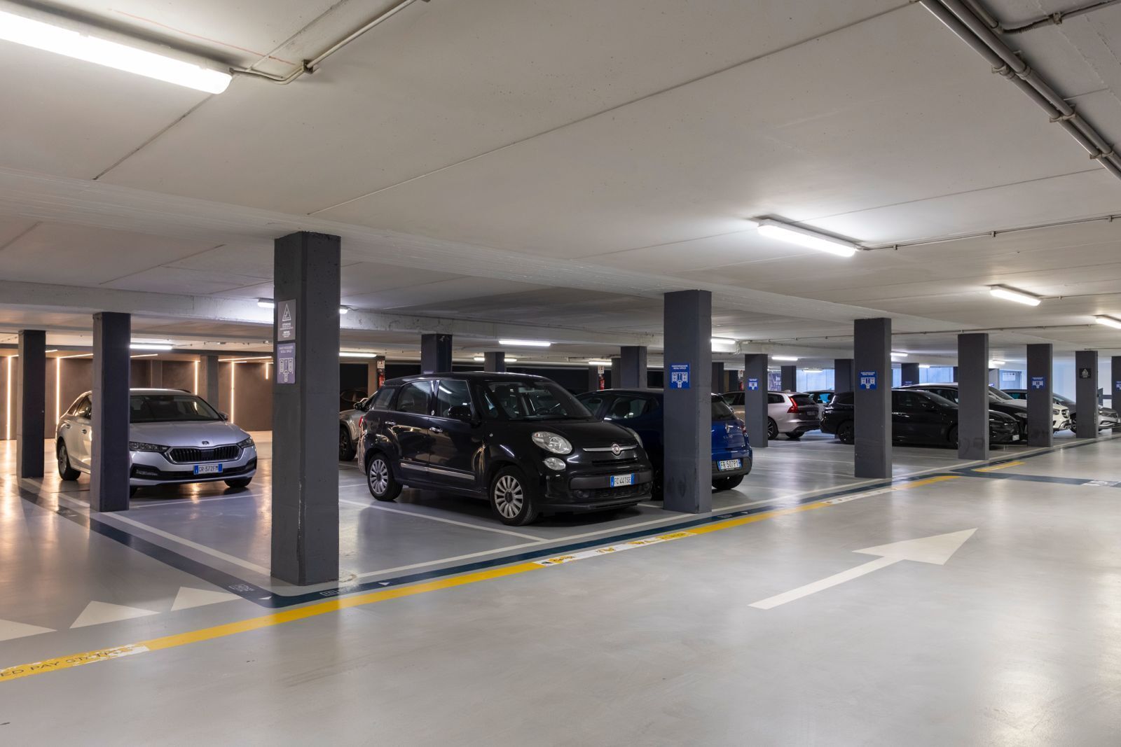 A multi-level parking garage with cars parked in designated spaces.